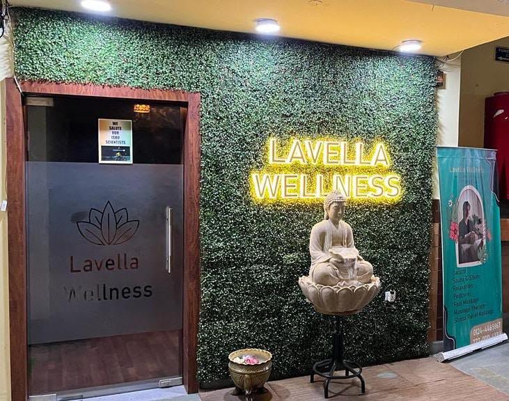 Lavella Wellness entrance with frosted glass door, lotus logo and neon wellness sign