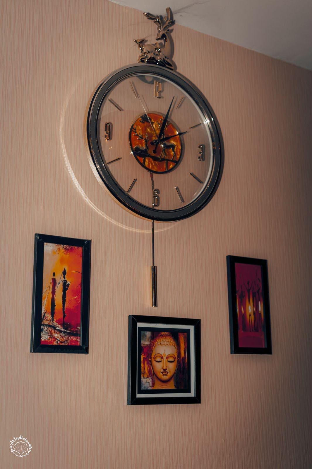 Lavella Wellness lounge wall — ornate golden pendulum clock flanked by framed Buddha and candlelight artworks